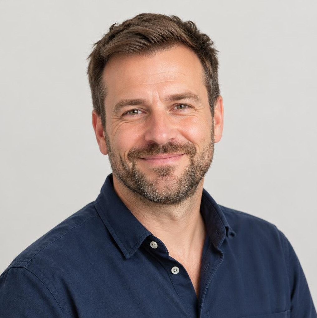 Portrait of a friendly man in his forties with short brown hair and a beard